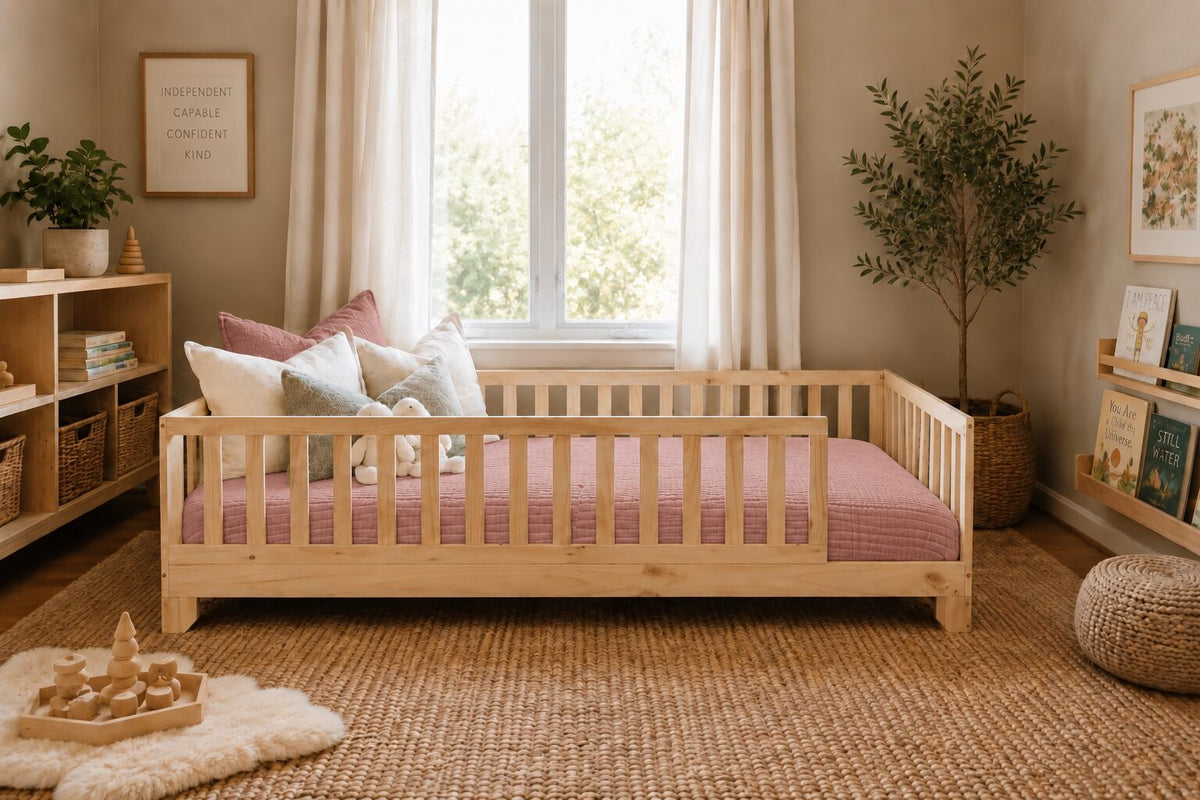 Dusty rose cotton muslin comforter on a natural pine Luca Montessori floor bed in a toddler bedroom