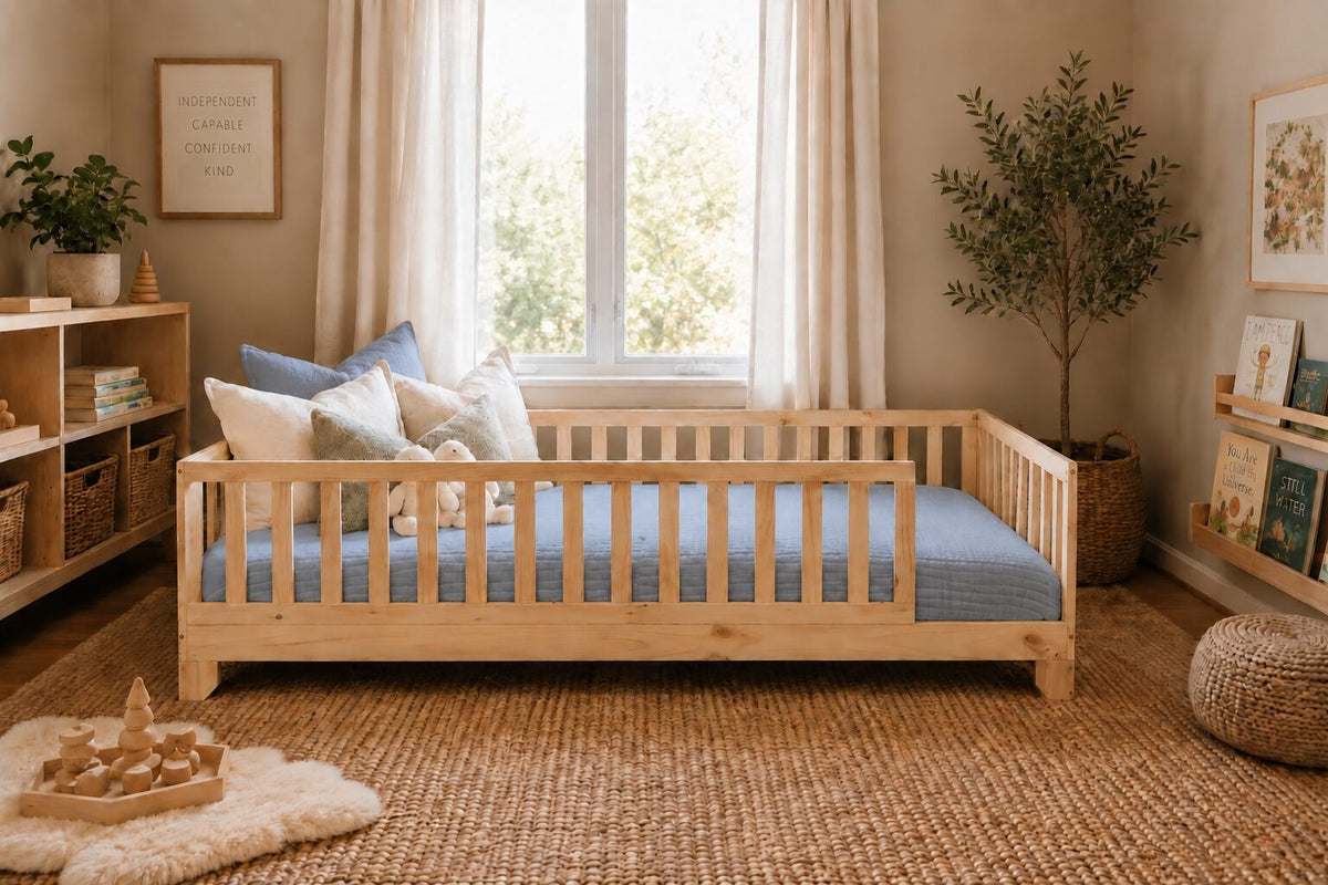 Heather blue cotton muslin comforter tucked on a natural wood Luca Montessori toddler floor bed