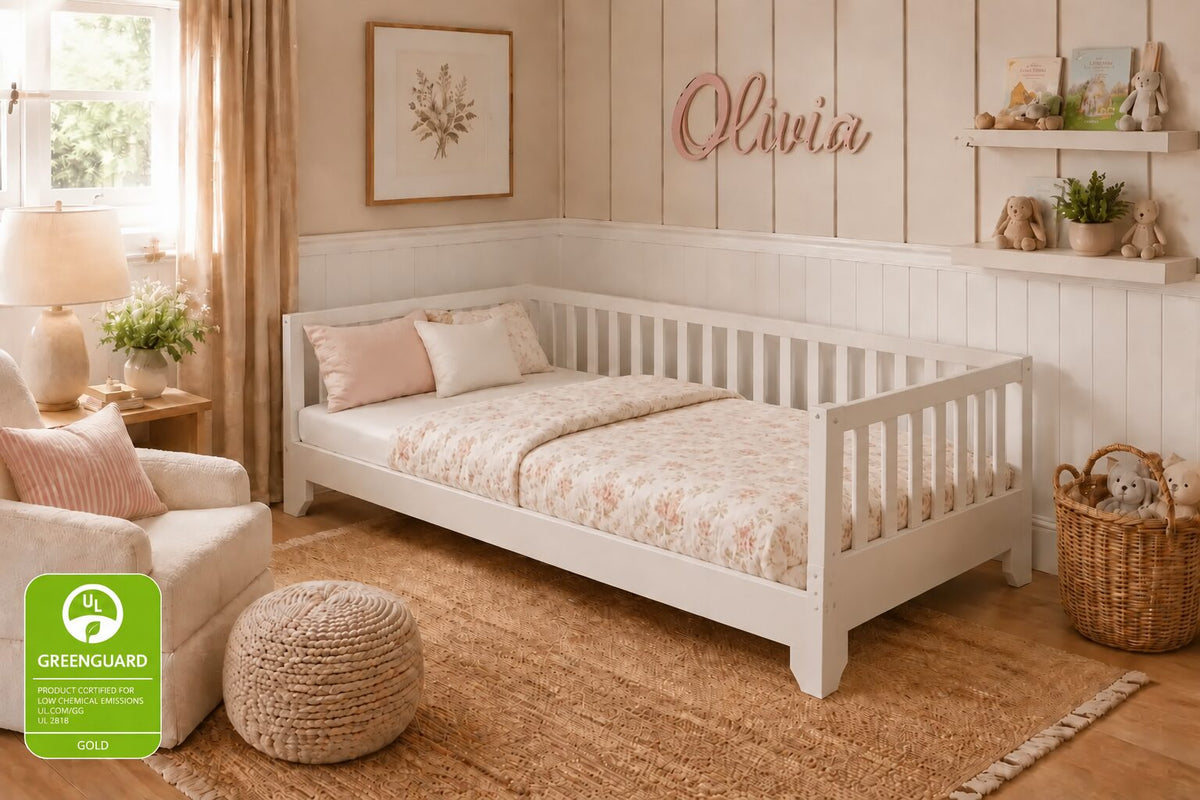 White Luca Montessori Toddler Floor Bed with front rail removed to create a daybed.