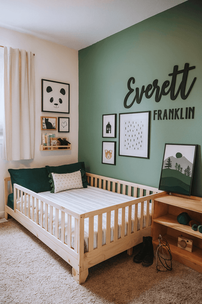 Luca Montessori Toddler Bed with Rails in a green-accented kids’ room, styled with wall art and bookshelf for a modern Montessori setup.