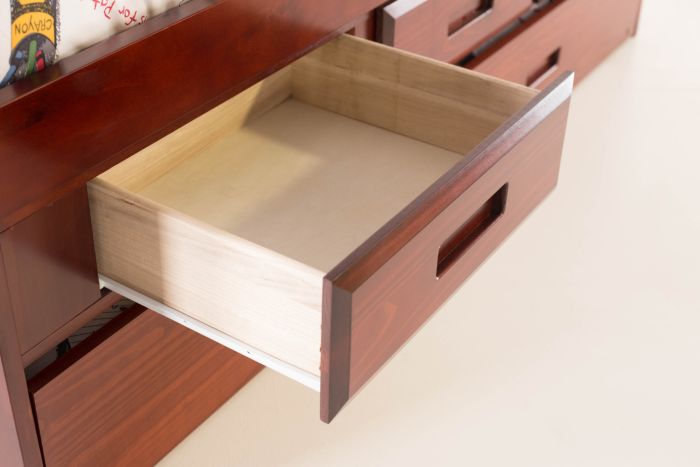 Wooden drawer being pulled out from a wooden cabinet.