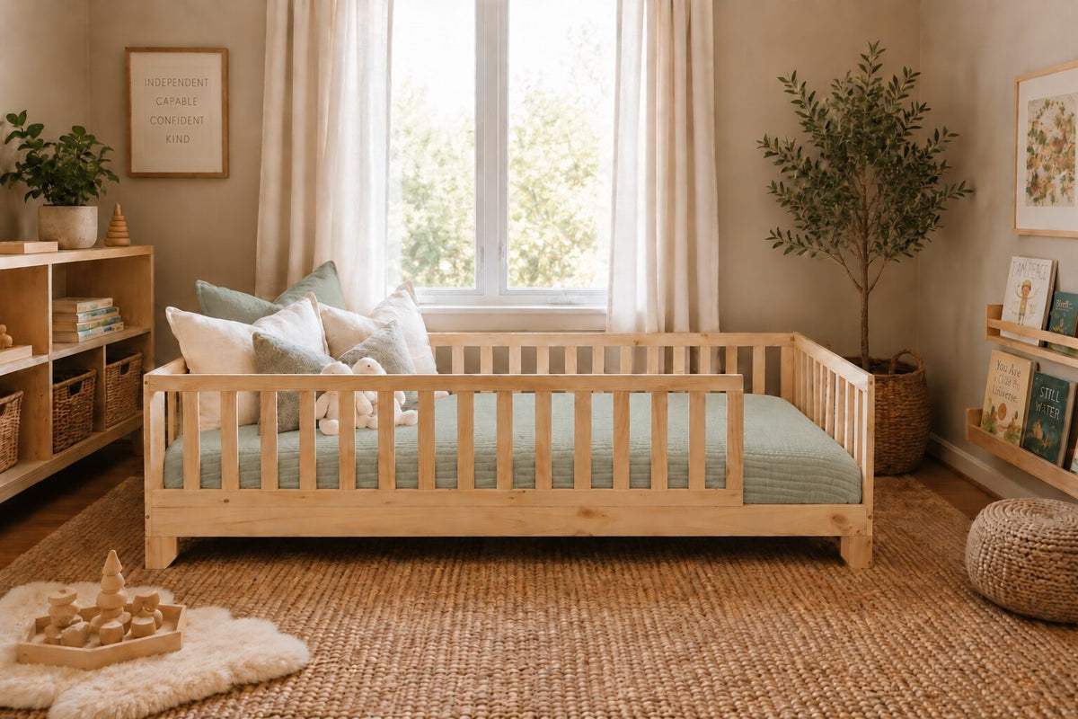 Sage green cotton muslin comforter tucked on a natural wood Luca Montessori floor bed with rails