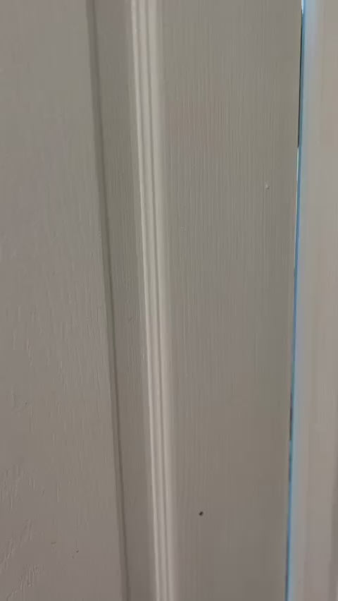 Close-up of a white door panel, not related to the Aiden Toddler House Bed with Rails product category or context.